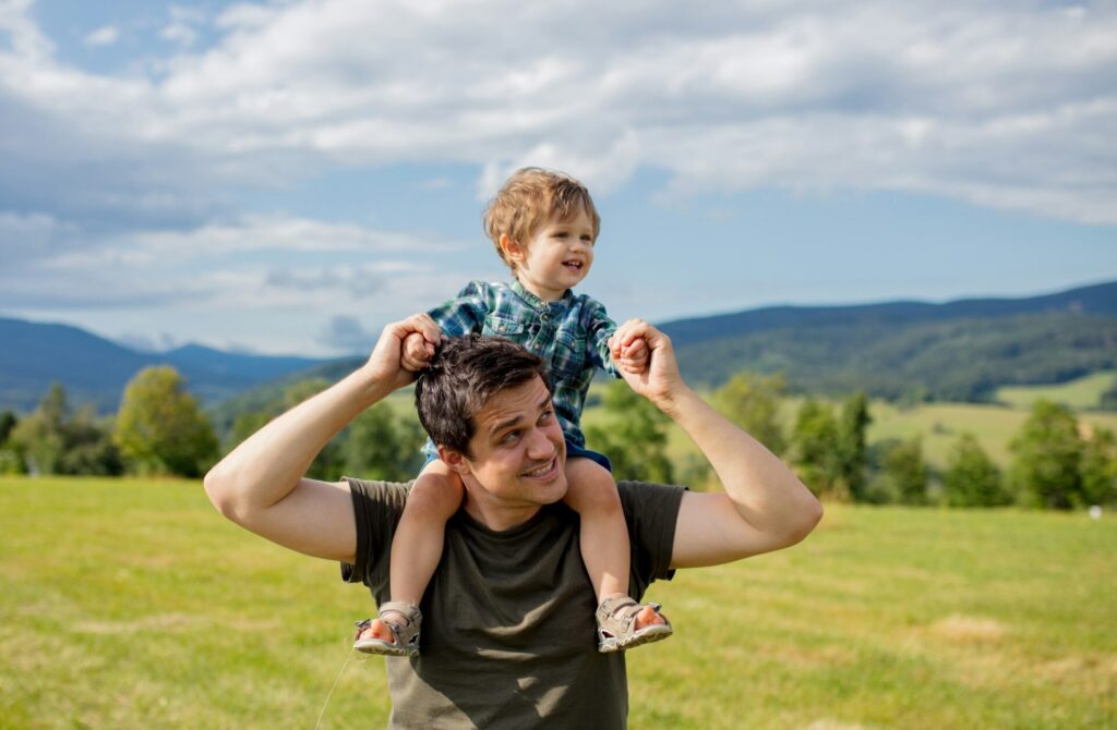 Father and toddler boy have a fun in a mountains