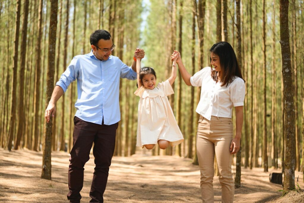 Happy family travel in pine forest park together on weekend